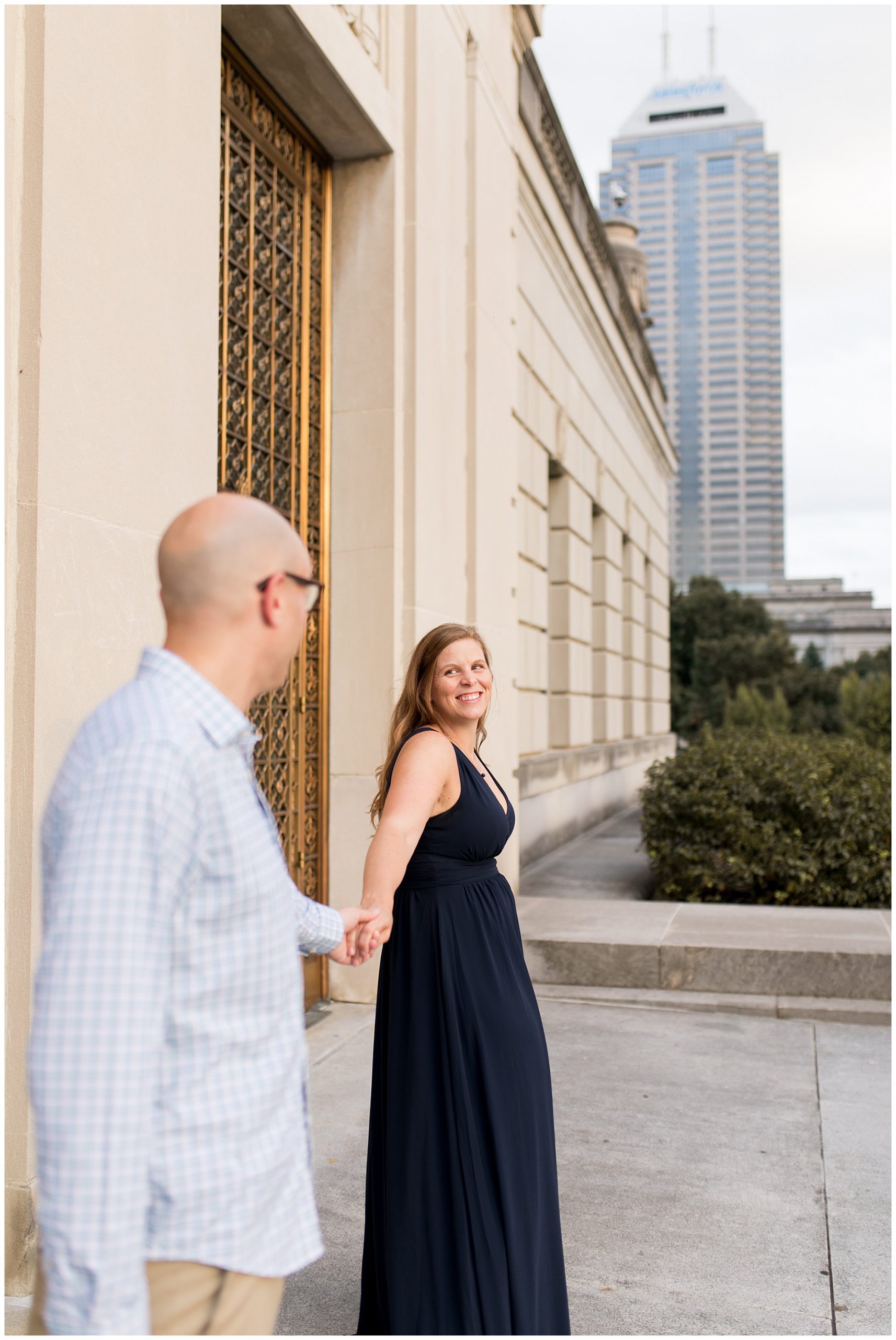 bride leads groom during Indianapolis engagement session at Indiana War Memorial