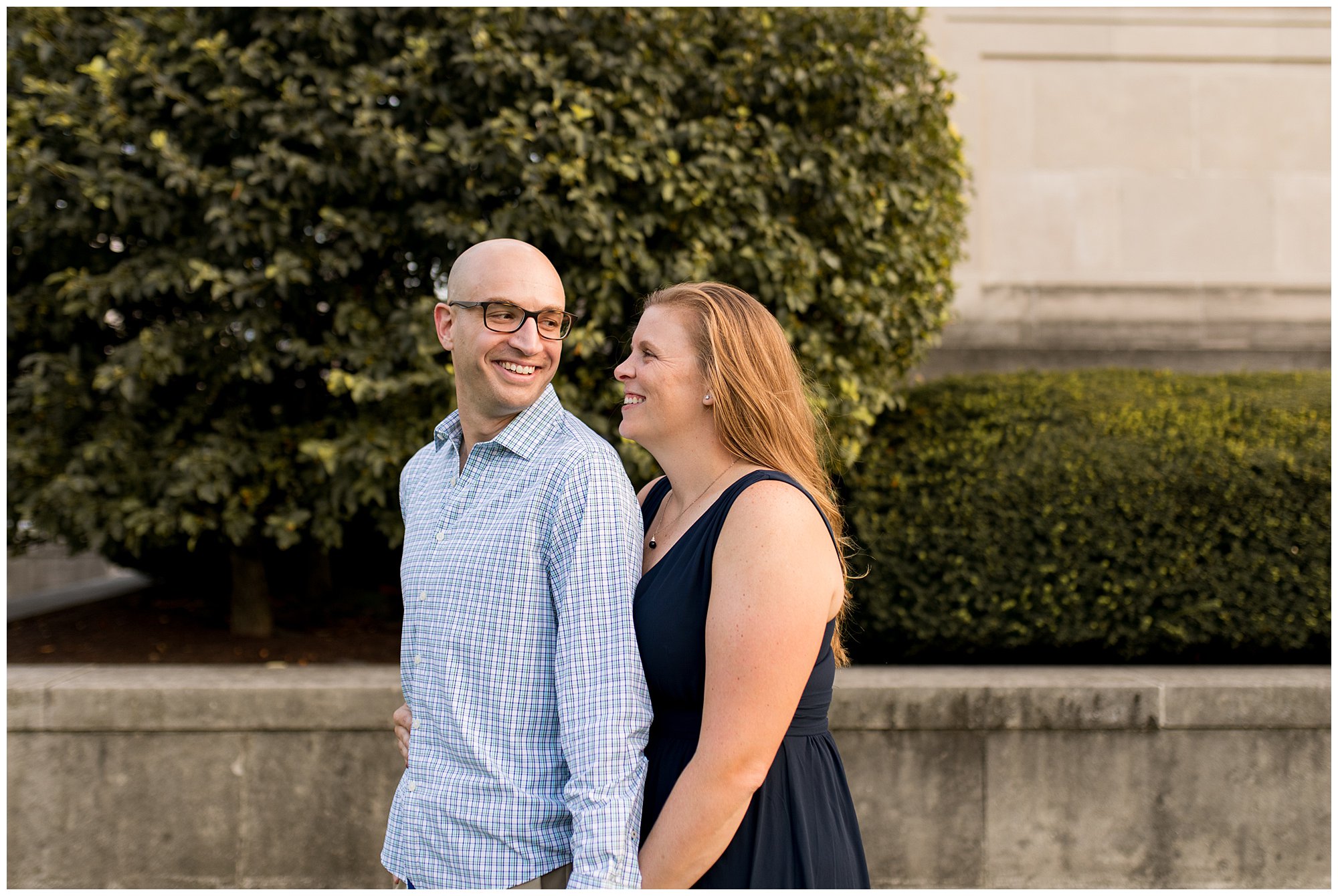 couple laughs together during Indiana War Memorial engagement session