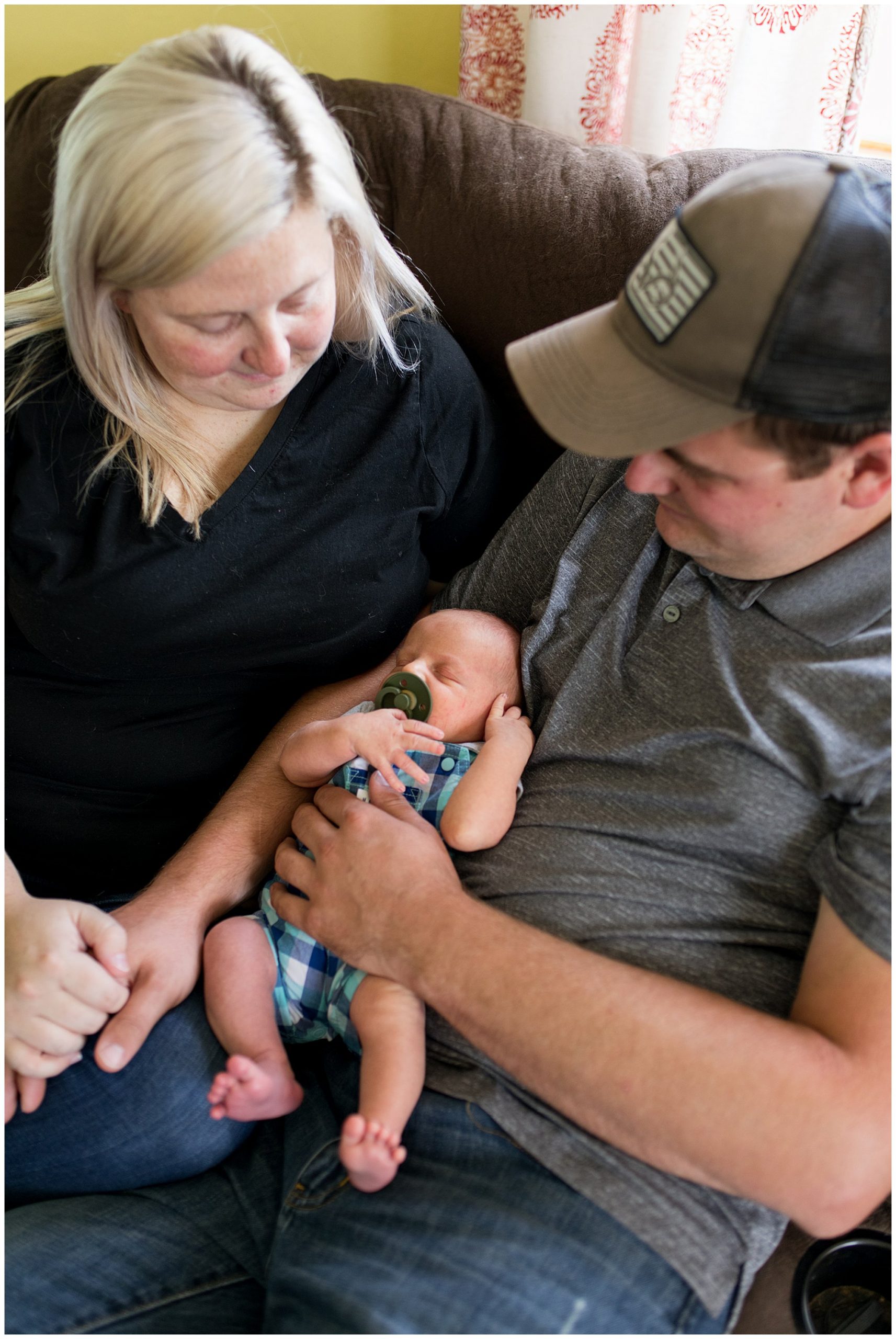 mom and dad hold baby during Muncie newborn session