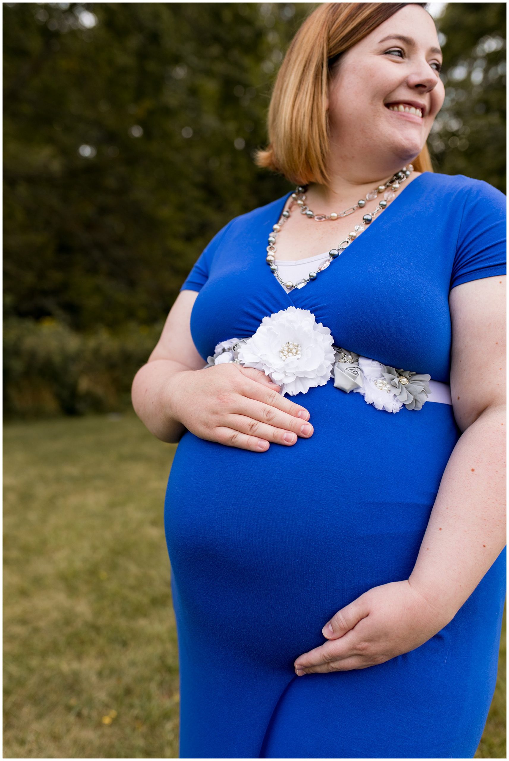 mom holds belly during maternity session at Jackson Morrow Park in Kokomo Indiana
