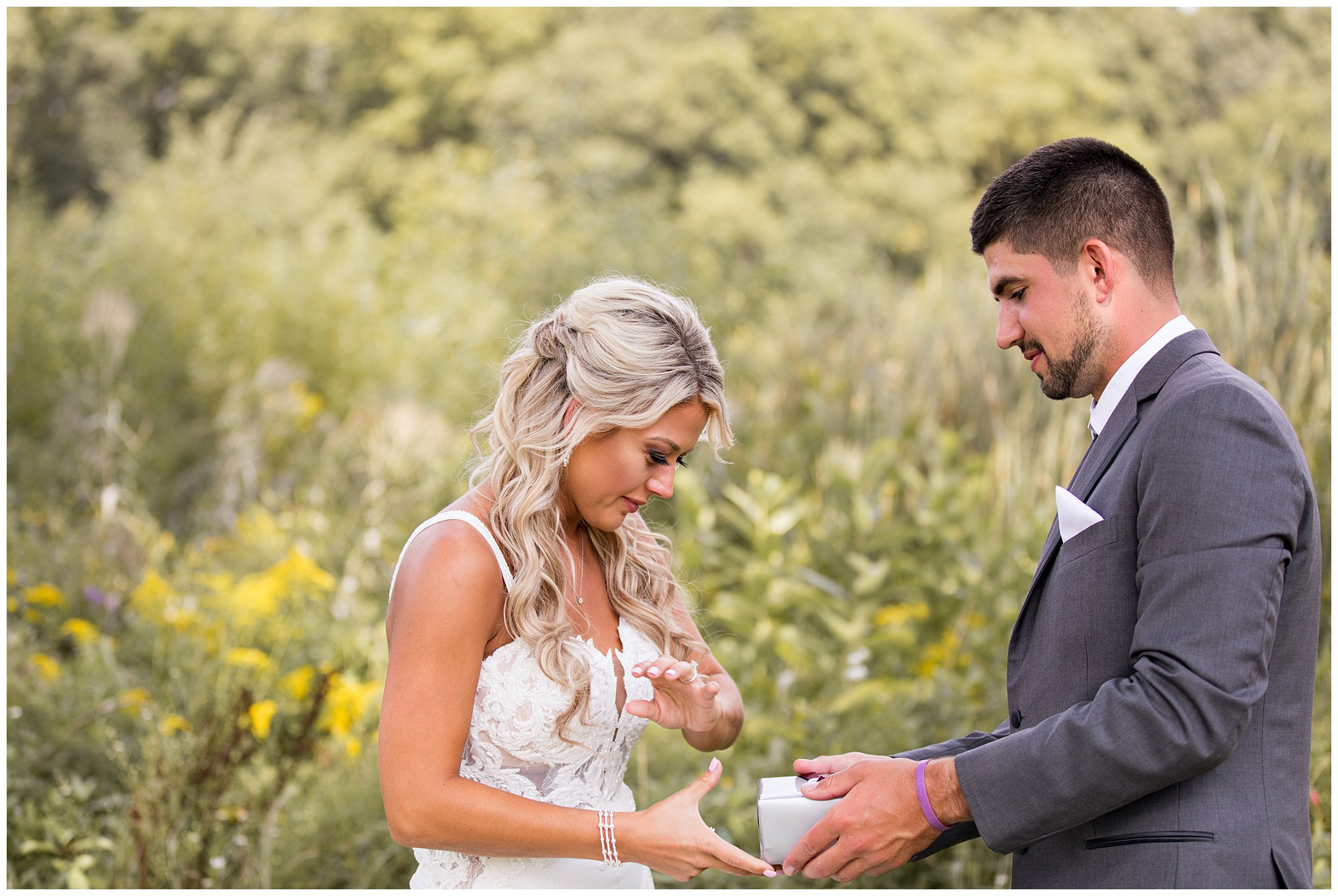 groom presents bride with gift during first look at Union 12 wedding venue