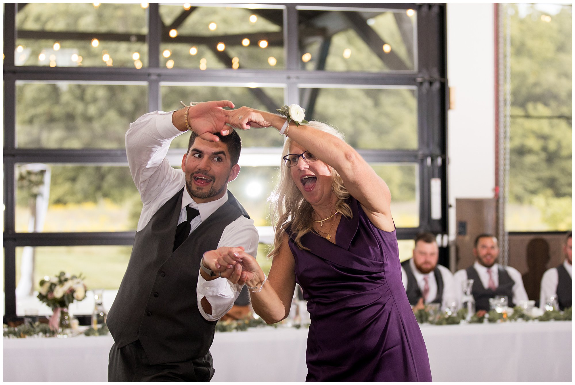 groom and mother dance together during Union 12 wedding reception in Fort Wayne
