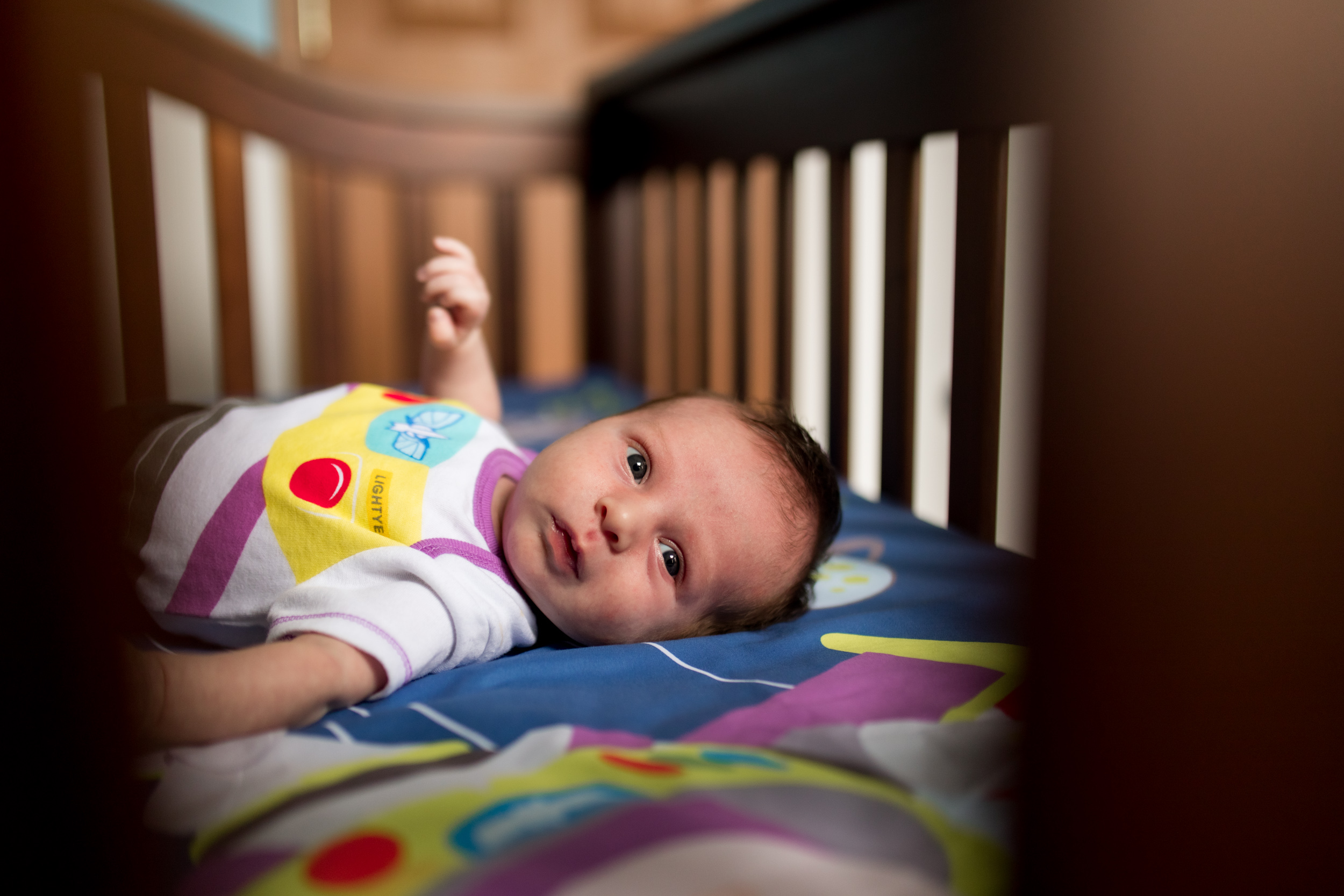 baby lies in crib during Kokomo newborn session