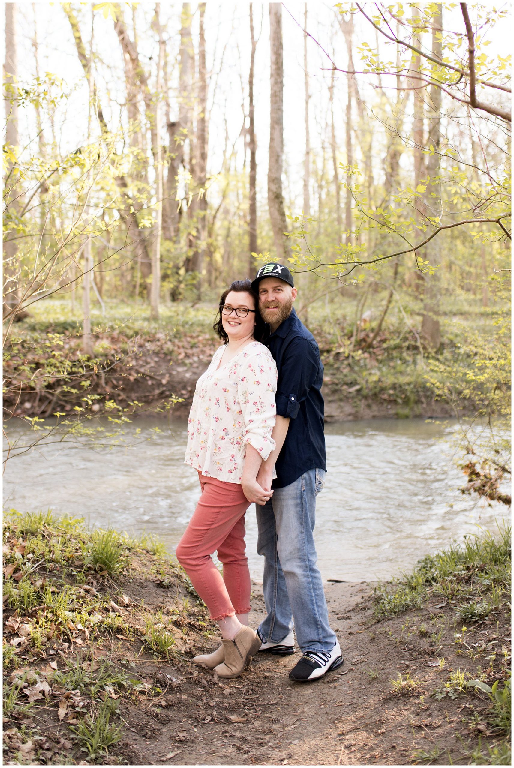 couple holds hands during Jackson Morrow Engagement session during spring