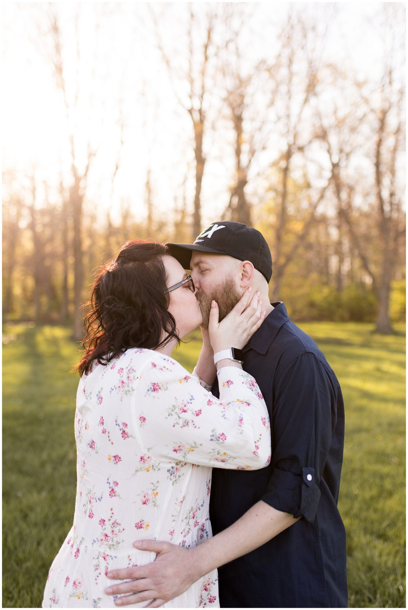 couple kisses during engagement session at Jackson Morrow Park in Kokomo