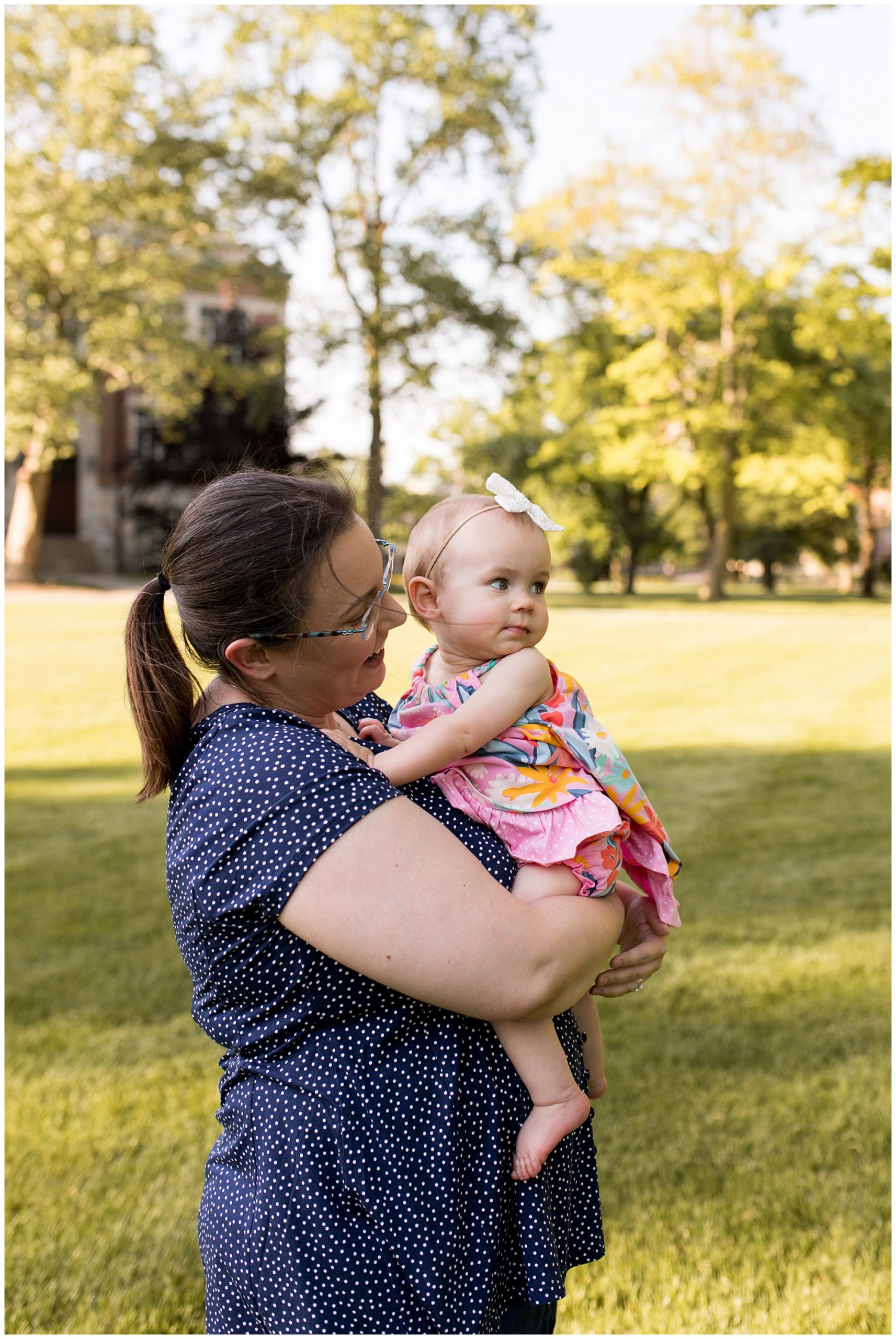 mom holds baby during family session at Ball State University