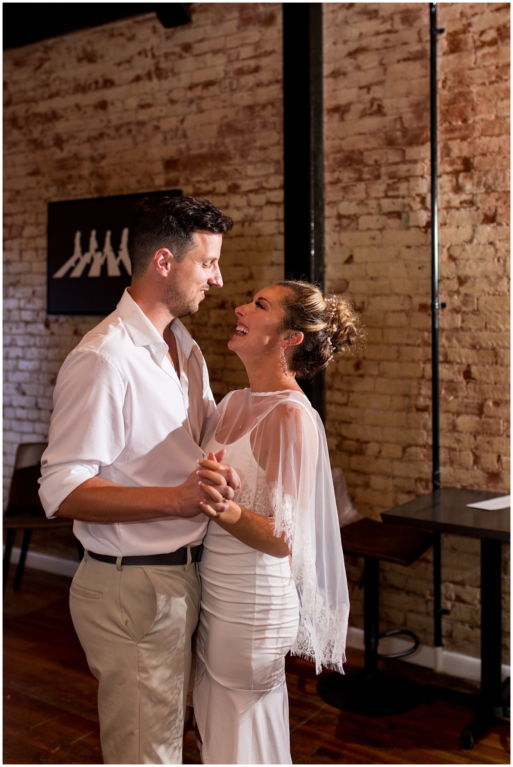 bride and groom dance during reception at Cafe Liefde in Syracuse, Indiana