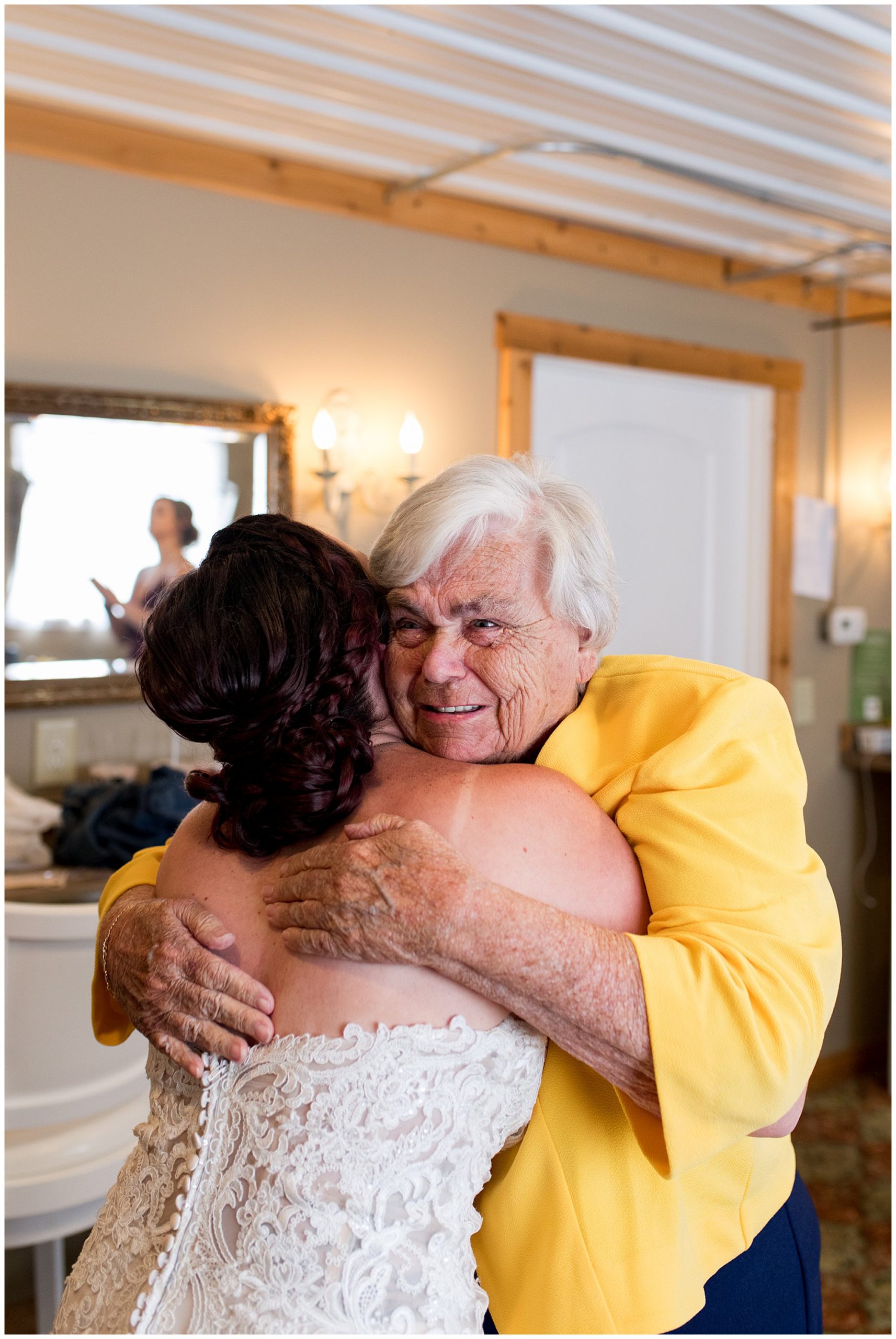 bride's grandma hugs her before wedding ceremony at Legacy Barn