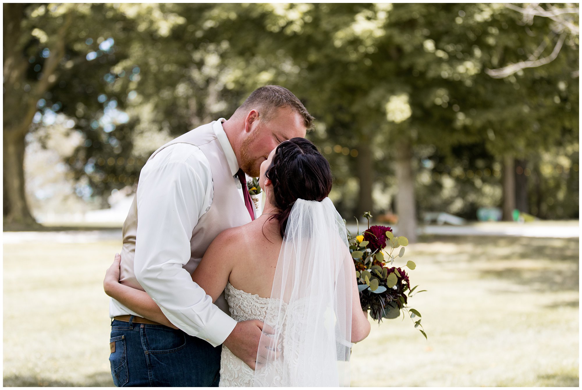 bride and groom kiss after first look