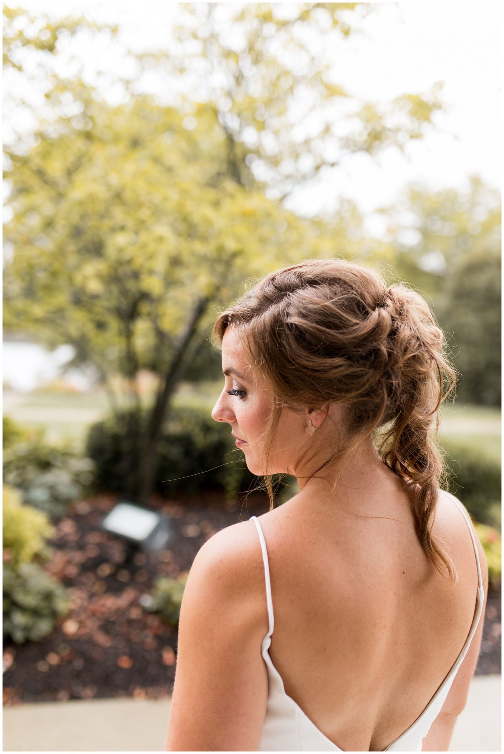 bride looks over shoulder before wedding at Montage in Indianapolis