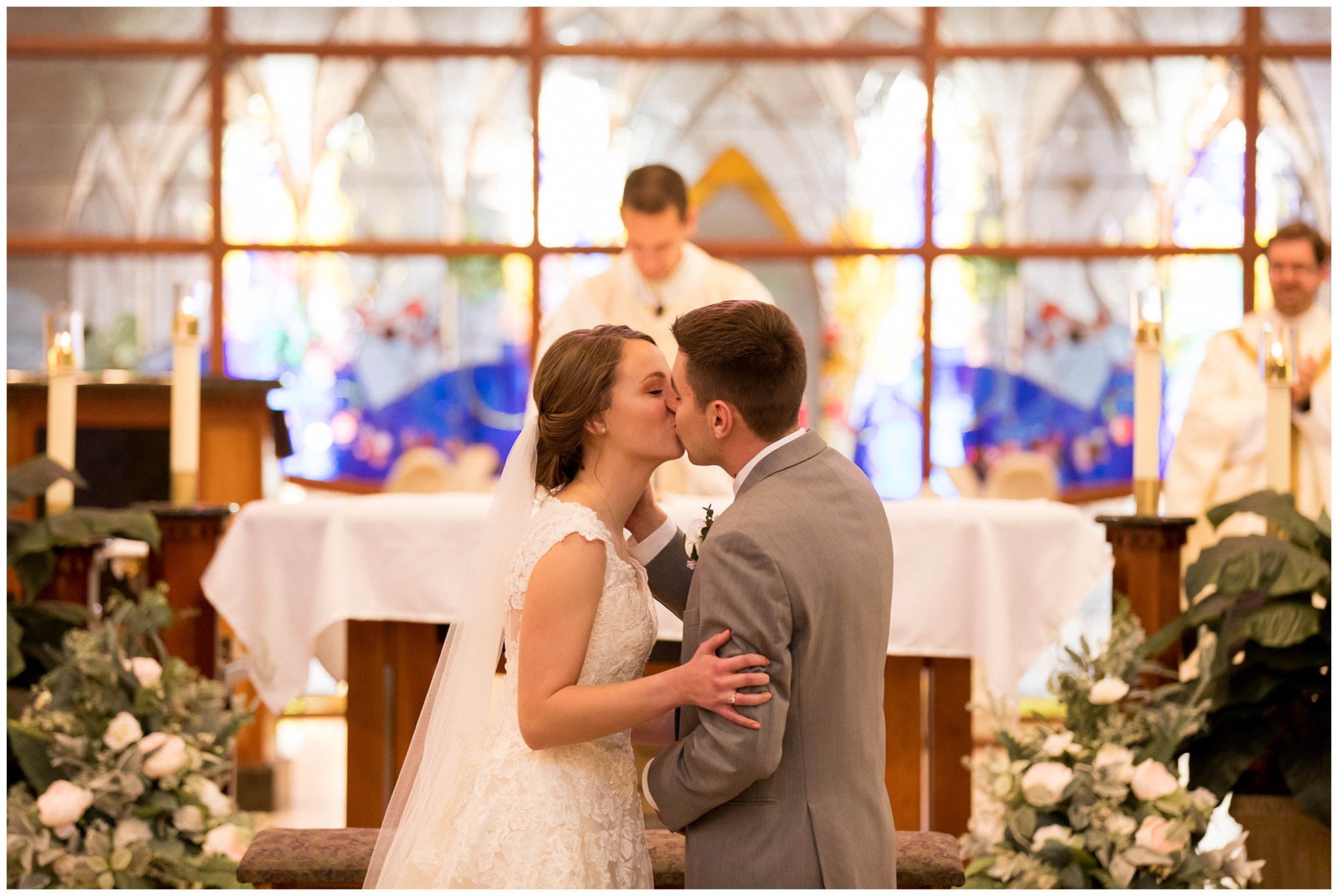 bride and groom first kiss after Catholic Mass at Saint Therese Catholic Church in Fort Wayne